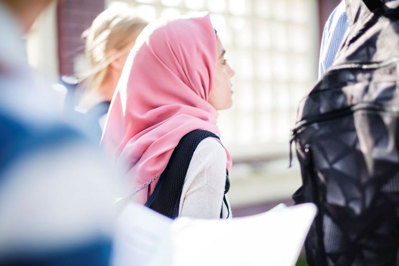 Ein Mädchen mit Kopftuch verfolgt aufmerksam den Schulunterricht.