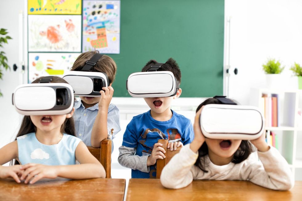 surprised students with virtual reality headset in classroom