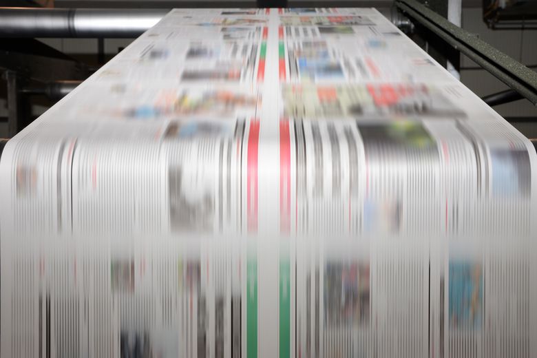 Offset printing press at work Zeitungspapier läuft durch die Druckmaschine.