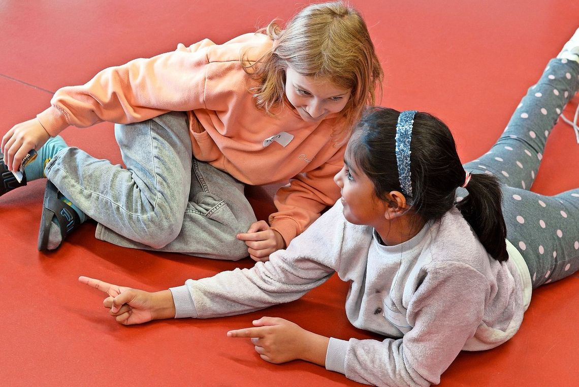 Kinder spielen am Boden.