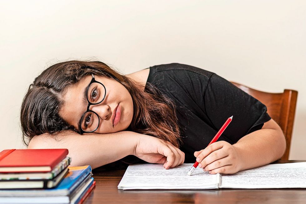 young girl tired of studying