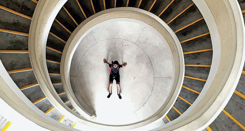 High Angle View Of Man At Bottom Of Spiral Staircase